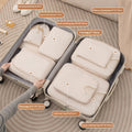 Eight beige packing organizers arranged in a suitcase; suitcase and contents not included