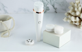 The Éclat Cleansing Brush — White · four heads